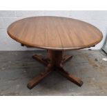 An extending circular dining table measuring 116cm dia, extending to approx. 167cm.