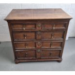 An oak chest of two over three graduated drawers having bun feet,