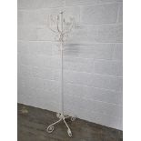 A contemporary white painted free standing hat stand.