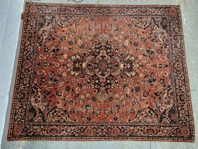 A rug in red floral pattern approx. 162 x 36cm.