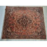 A rug in red floral pattern approx. 162 x 36cm.