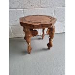 A low octagonal planter table having carved elephant legs with bone tusks measuring approx.