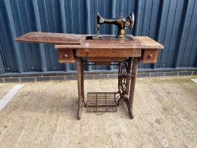 A Singer sewing machine table having metal base and machine numbered Y1119095.