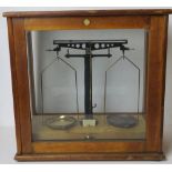 A set of balance scales in glazed case by Philip Harris Ltd Birmingham.