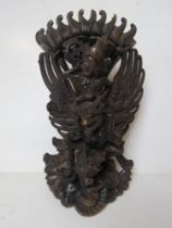 An Indo-Asian carved hardwood deity figurine, a/f, standing approx 35cm high.