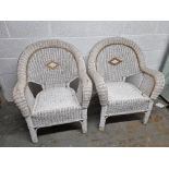 A pair of wicker conservatory chairs.
