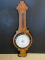 An Edwardian inlaid wooden Aneroid barometer, thermometer missing.