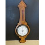 An Edwardian inlaid wooden Aneroid barometer, thermometer missing.