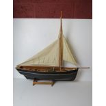 A model fishing vessel on stand measuring approx 76cm in length,