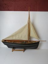 A model fishing vessel on stand measuring approx 76cm in length,