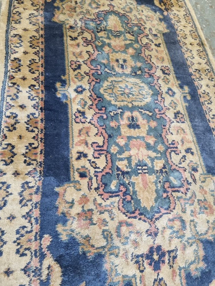 A woollen runner in cream and blue ground in need of cleaning, measuring approx. 240 x 68cm. - Image 2 of 3