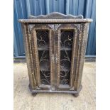 An unusual faux crocodile leather and ironwork cabinet.