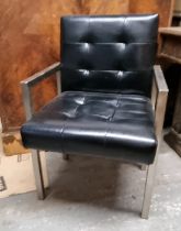A contemporary 1950s style black leatherette office chair.