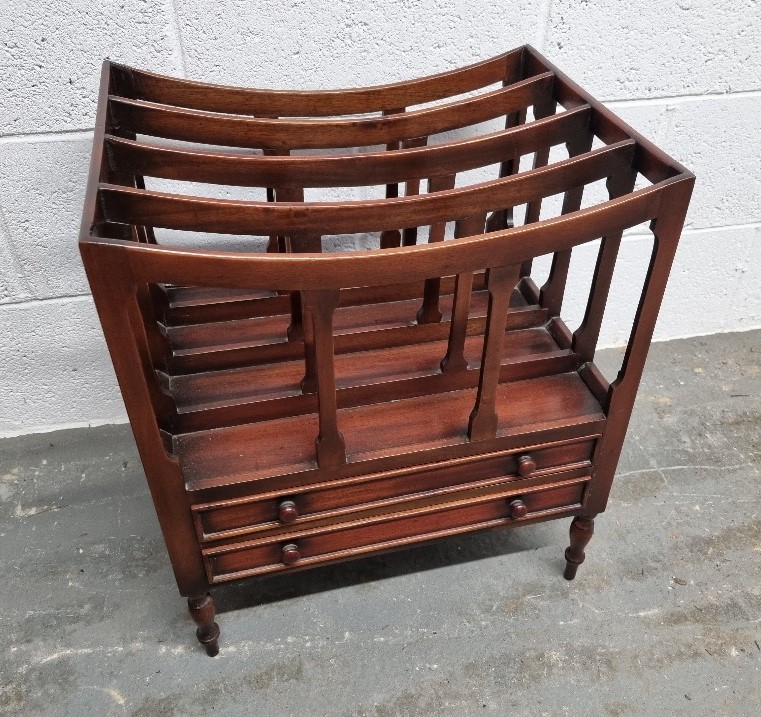 A mahogany Canterbury magazine rack raised over turned feet and having two drawers under approx. 47.