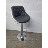 A contemporary leatherette kitchen bar stool.