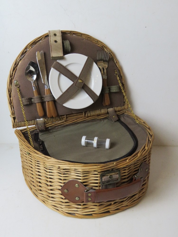 A wicker picnic basket for two having thermal lined compartment, cutlery, plates, etc.