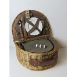 A wicker picnic basket for two having thermal lined compartment, cutlery, plates, etc.