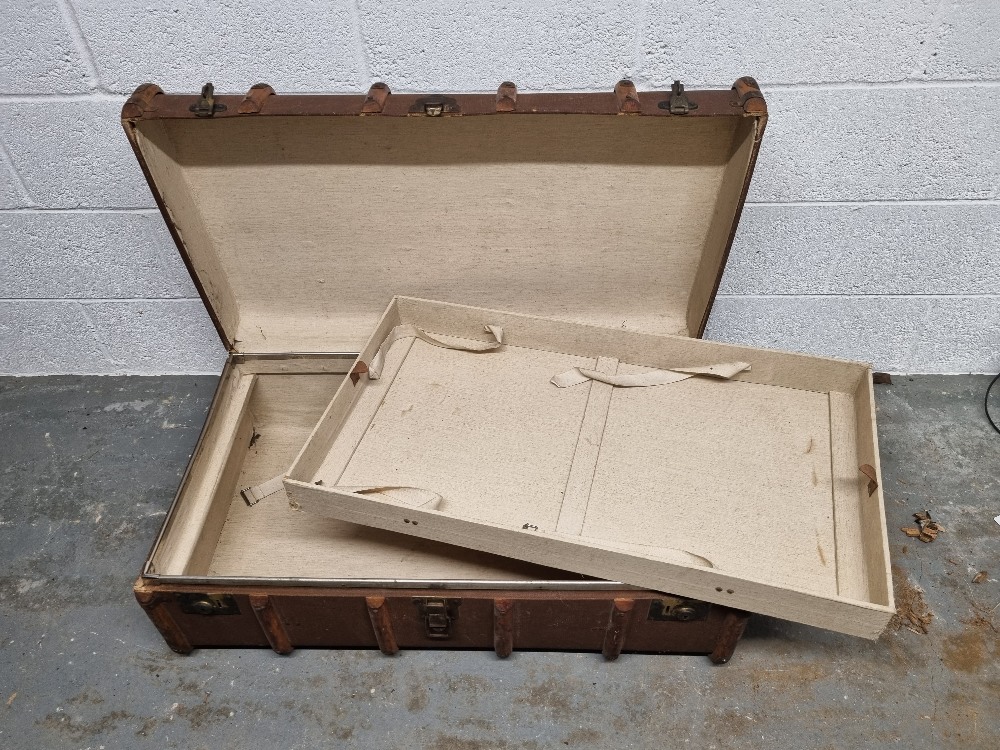 A steamer trunk having drop-in slide within measuring approx. 91cm wide.