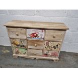 A contemporary apothecary style low cabinet having botanical themed drawers measuring approx.