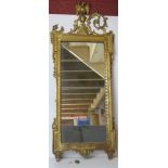 A carved and gilded wooden framed wall mirror in the Regency style,