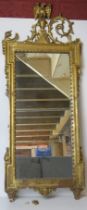 A carved and gilded wooden framed wall mirror in the Regency style,