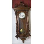 A mahogany wall clock having brass and white enamelled dial,