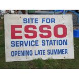 A large painted board 'Site for Esso Service Station Opening Late Summer' measuring approx 122 x