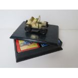 A tabletop display box having vintage model motorcar upon and opening to reveal two packs of
