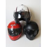 Three motorbike helmets for decorative display purposes only.