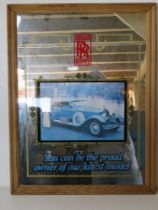 A Rolls Royce advertising mirror in pine frame measuring 50 x 66cm overall.