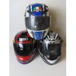 Three motorbike helmets for decorative display purposes only.