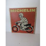 A printed aluminium Michelin Mr Bibendum on motorbike sign measuring approx 43 x 44.5cm.