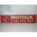 A painted metal Honda Genuine Spare Parts sign measuring approx 94 x 23cm.
