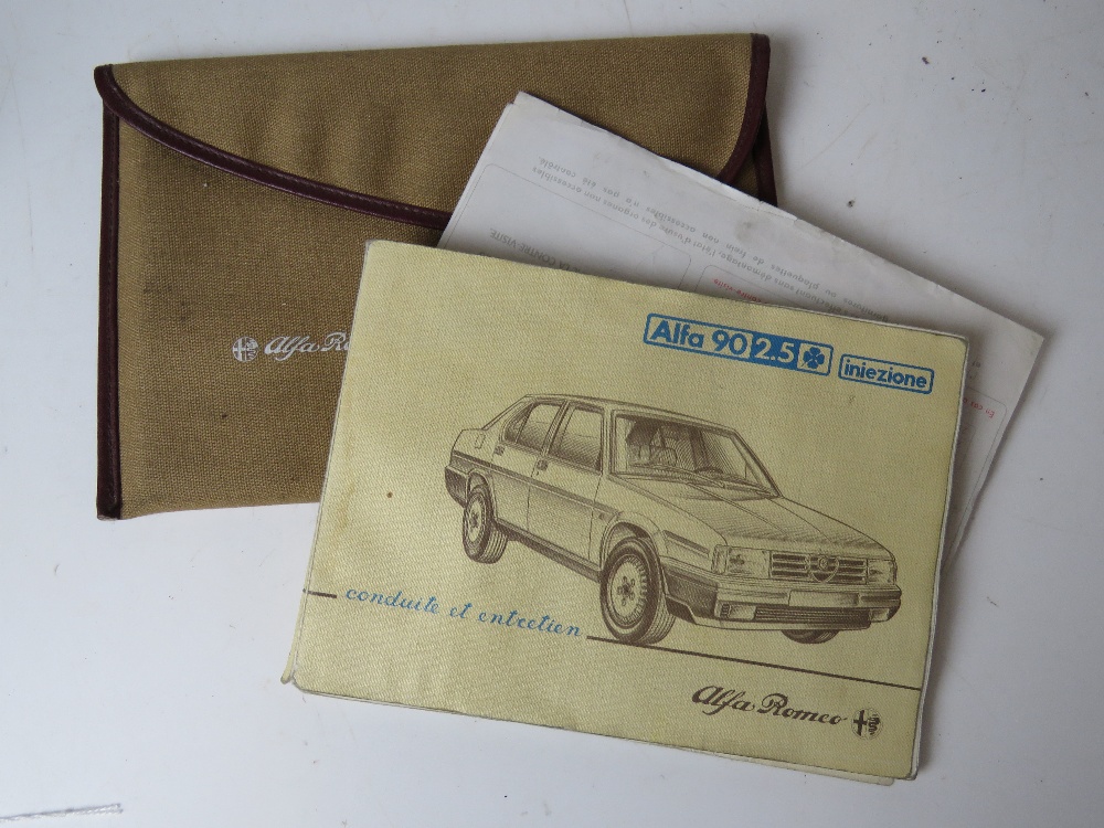 An Alfa Romeo 90 2.5 handbook in original cloth pouch.