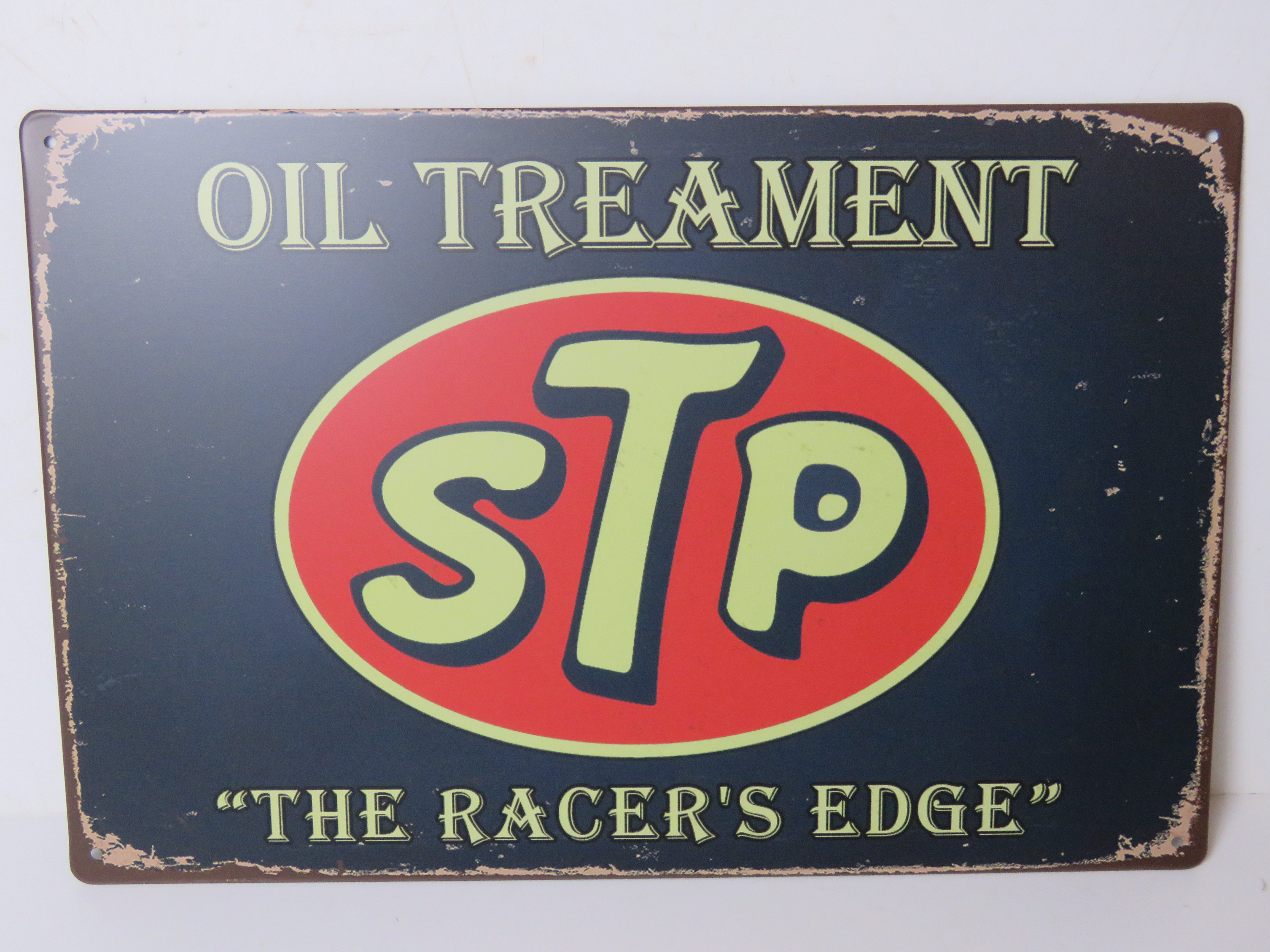 A contemporary metal garage STP oil treatment advertising sign 'The Racers Edge', 30 x 20cm.