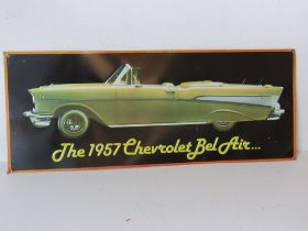 A contemporary metal sign 'The 1957 Chevrolet Bel Air' approx 56cm wide.