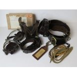 A set of brown leather belts, stirrups,