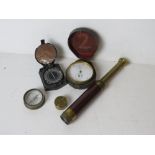 A brass stopwatch together with a monocle and two compasses,