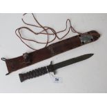 A reproduction M6 fighting knife with scabbard, dated 43 on the scabbard.