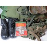 A Berghaus camouflage military rucksack containing a large quantity of kit inc black leather boots,