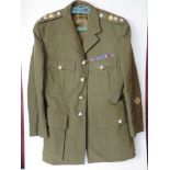 A British Army No 2 dress tunic, having badges and patches upon.
