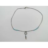A Native American Navajo style silver and turquoise beaded necklace with dream catcher pendant,