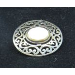 A silver Celtic style brooch having central mother of pearl panel, in presentation box.