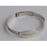 A silver Christening bangle.