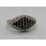 A silver cocktail ring encrusted with white and black cz stones, stamped 925, size S.