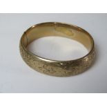 A 9ct gold plated hinged bangle having engraved fleur de lis pattern. Approx 6 x 5.
