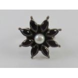 An adjustable silver ring of floral form approx size Q, stamped 925.