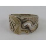A silver ring having carved Aztec pattern upon, marks indistinct, size O.