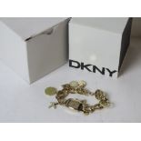 A ladies DKNY charm bracelet style wrist watch in original packaging numbered 11005 NY-4831