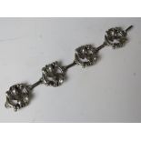 An 800 silver arts and crafts style four panel articulated bracelet having ivy leaf design to each